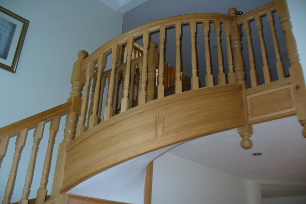 Circular section oak staircase - With circular raised and fielded panels